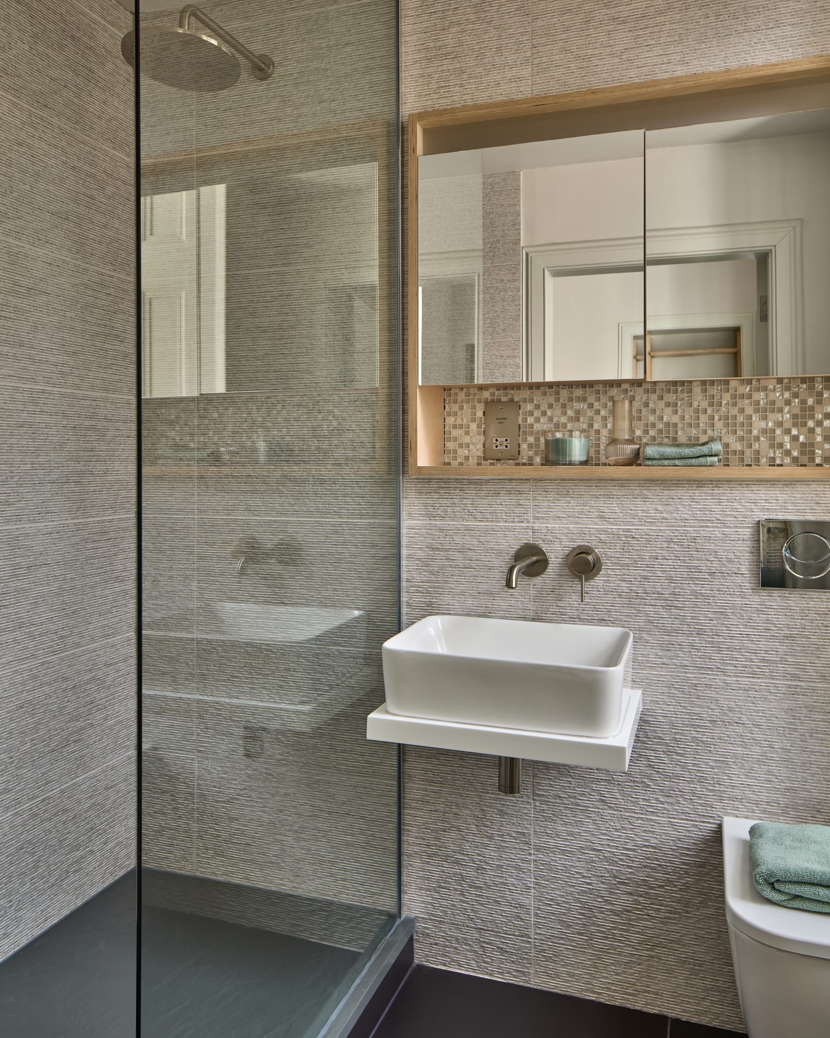 Bathroom with twin basins and mosaic tiling