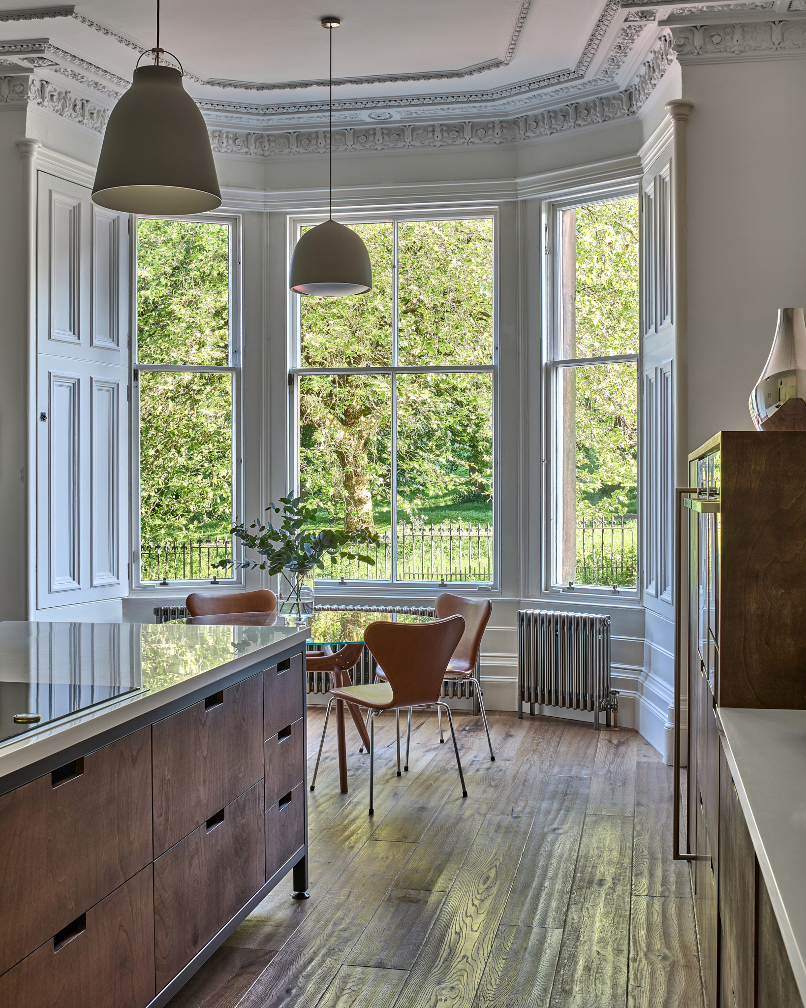 Kitchen and dining area with garden views through a bay window