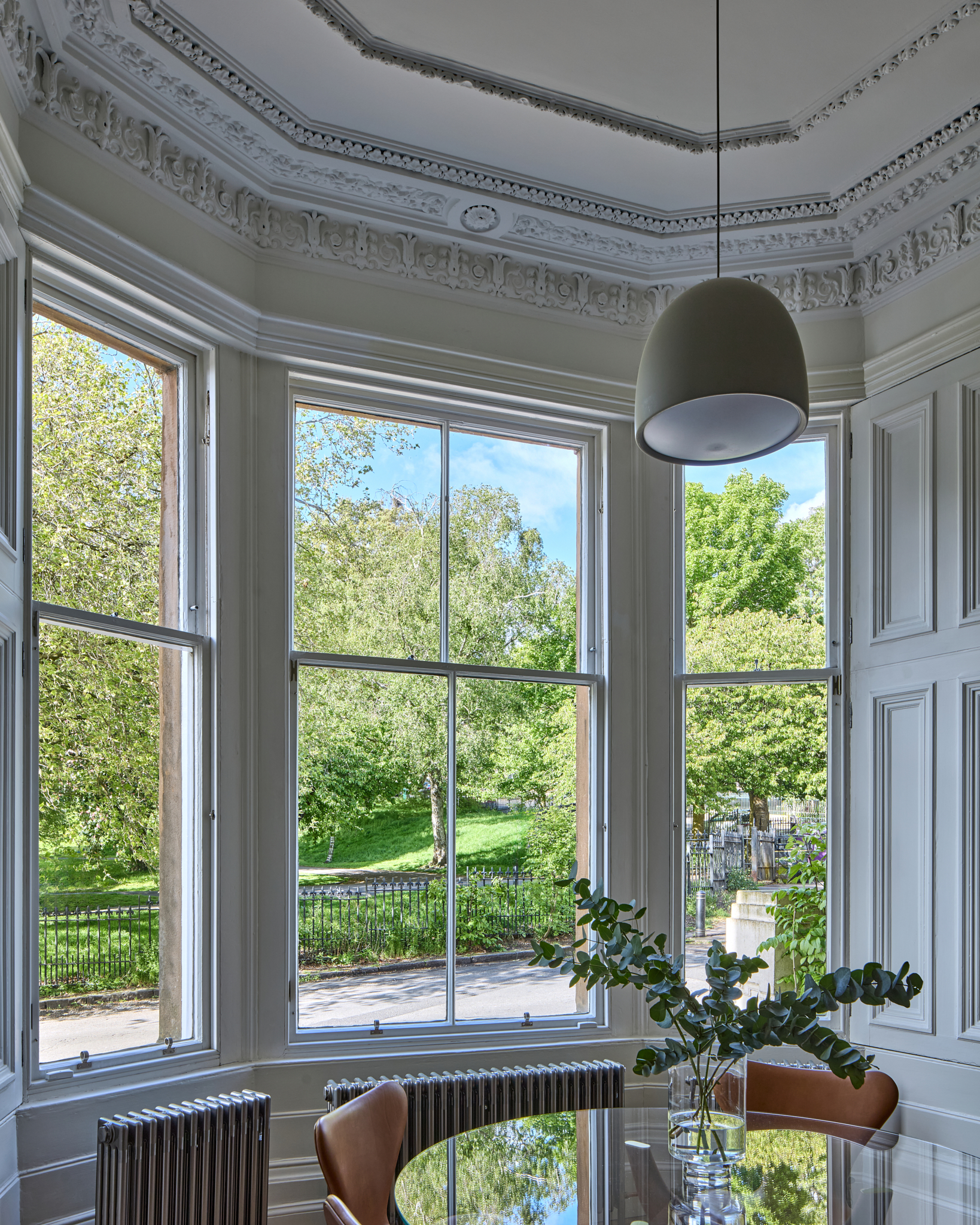 Bedroom bay window with original cornice and pendant light